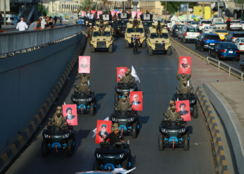 Members and supporters of Iraq's Iran-backed Popular Mobilization Forces mark the withdrawal of U.S. forces from Iraq. dpa via Reuters Connect